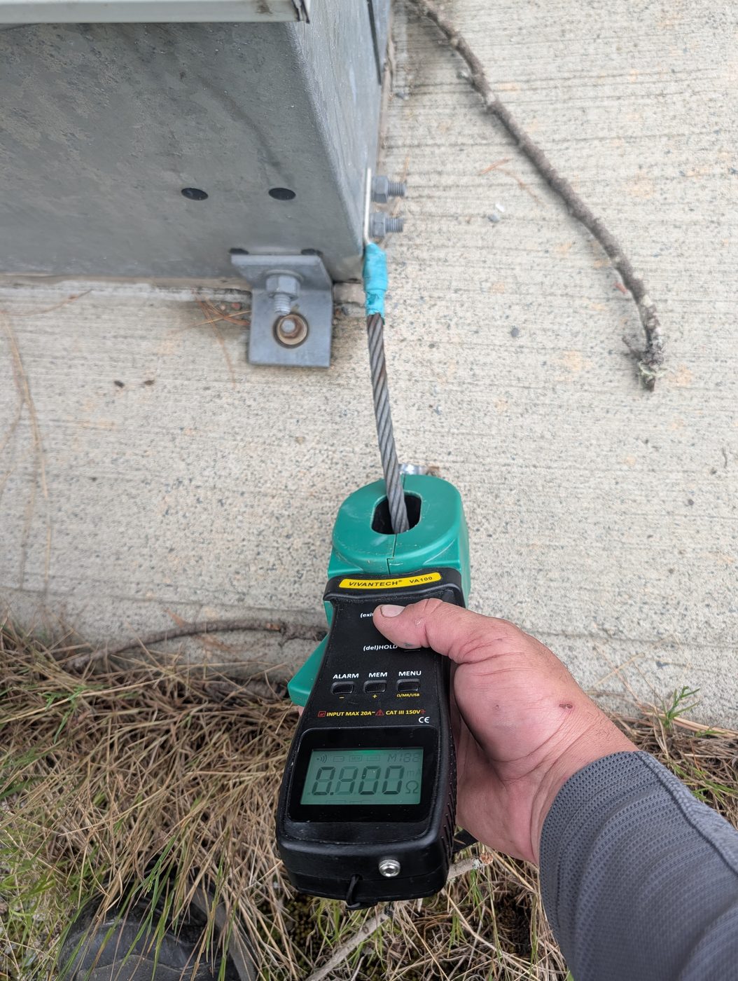Clamp-on ground resistance meter testing a tower ground