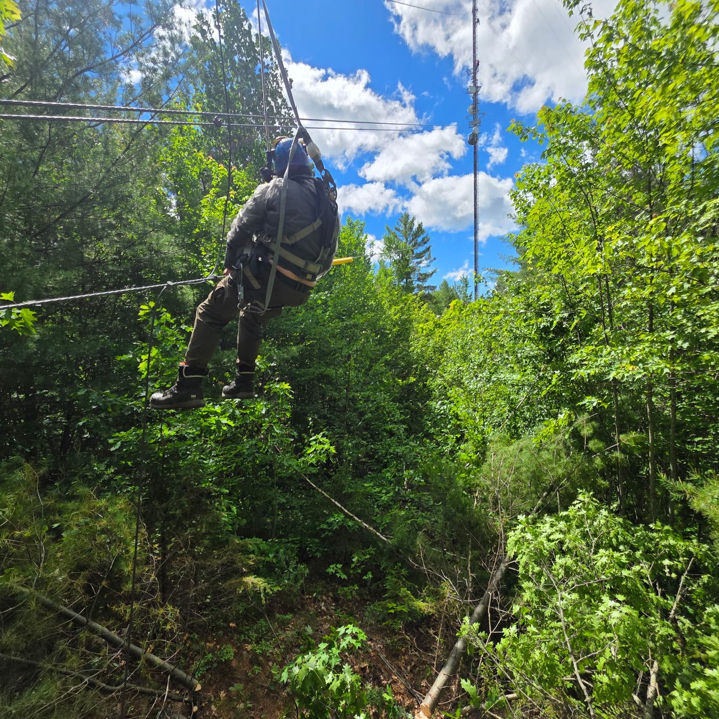 Certified climber working a guyed tower's guy wires